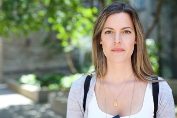 Young Female university college student arrives on campus for new school year