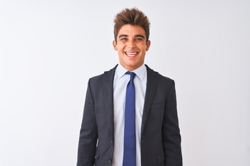 Young handsome businessman wearing suit standing over isolated white background with a happy and cool smile on face. Lucky person.