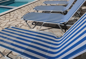 Swimming pool with sun loungers