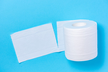 Eco-friendly white toilet paper on a blue background close-up