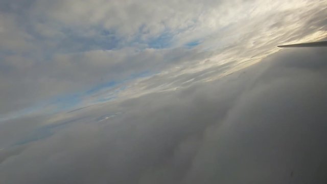 The plane leaves the dense clouds.