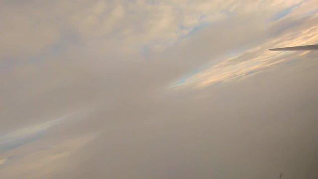 The plane leaves the dense clouds after take off.