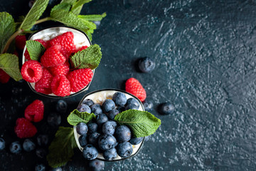 Creamy dessert with cream, raspberry and blueberry garnished with fresh mint. © Igor Normann