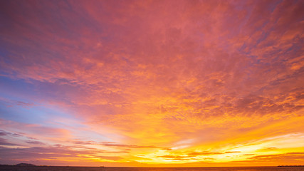 Amazing sunset.Colorful sky in the sunset. Natural Sunset Sunrise Over Field Or Meadow. Bright Dramatic Sky And Dark Ground.Sky background.