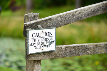 Caution this bridge may be slippery when wet sign