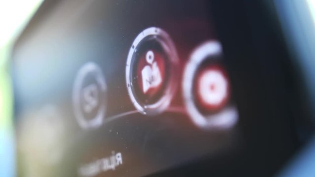 Close-up of on-board car display with settings of user's menu to choose by driver. Icons of connection, navigation and options displayed on monitor, modern automative technology concept