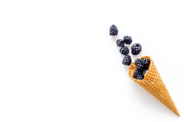 Fresh berries in waffle cones on white background top view mock up
