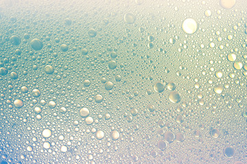 textured background of soap bubbles on the water