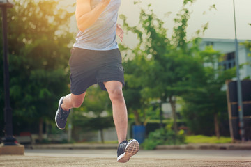Portrait of fit and sporty young man running in the city. Concept sport and a healthy lifestyle in...