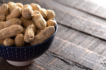 Raw In Shell Peanuts on a Wooden Kitchen Table