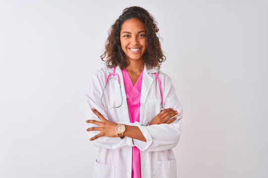 Young brazilian doctor woman wearing stethoscope standing over isolated white background happy face smiling with crossed arms looking at the camera. Positive person.