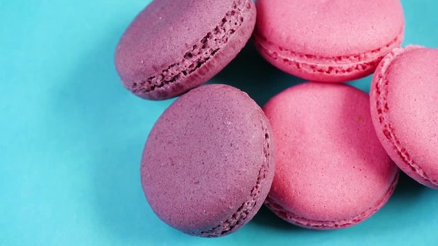Pastel background for the theme of food. Pink cookies or macaroons lying on a blue background.