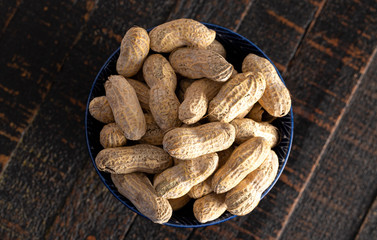 Raw In Shell Peanuts on a Wooden Kitchen Table
