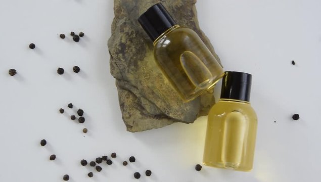 Bottles with black peper essential oil. Natural healthy cosmetic treatment products