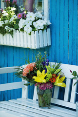 Beautiful flower bouquet on a garden bench