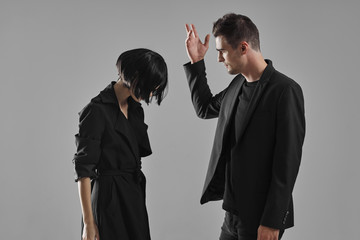man and woman fighting over white background