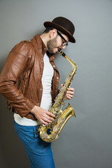 saxophone players on grey background. Saxophonist jazz man with Sax. Music concept