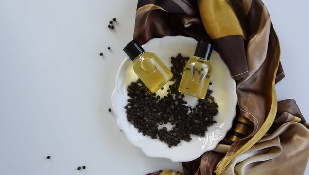Bottles with black peper essential oil. Natural healthy cosmetic treatment products