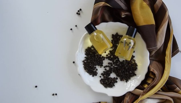 Bottles with black peper essential oil. Natural healthy cosmetic treatment products