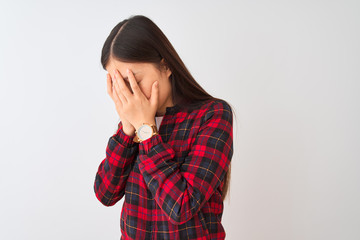 Young chinese woman wearing casual jacket standing over isolated white background with sad expression covering face with hands while crying. Depression concept.