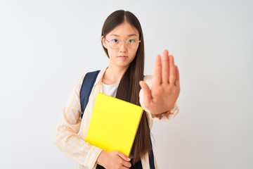 Chinese student woman wearing glasses backpack book over isolated white background with open hand doing stop sign with serious and confident expression, defense gesture