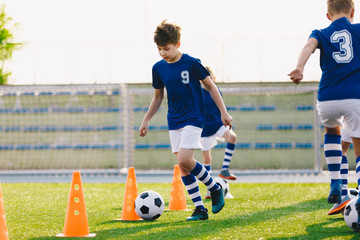 Soccer Drills: The Slalom Drill with Ball. Soccer Football Training Session. Young Boys Practice Slalom Drill. Junior Football Club Training Time