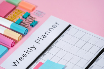 Stationery and planner on pink pastel background