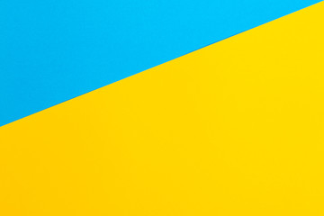 Color papers geometry flat composition background with yellow and blue tones