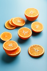 Slices and slices of orange pulp on a bright blue background as a textural background, the substrate. Full screen Flat lay, top view. Food background