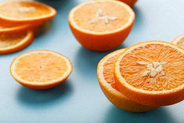Slices and slices of orange pulp on a bright blue background as a textural background, the substrate. Full screen Flat lay, top view. Food background