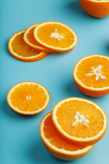 Slices and slices of orange pulp on a bright blue background as a textural background, the substrate. Full screen Flat lay, top view. Food background