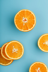 Slices and slices of orange pulp on a bright blue background as a textural background, the substrate. Full screen Flat lay, top view. Food background