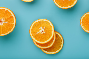 Slices and slices of orange pulp on a bright blue background as a textural background, the substrate. Full screen Flat lay, top view. Food background