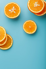 Slices and slices of orange pulp on a bright blue background as a textural background, the substrate. Full screen Flat lay, top view. Food background