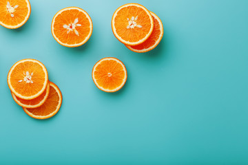 Slices and slices of orange pulp on a bright blue background as a textural background, the substrate. Full screen Flat lay, top view. Food background