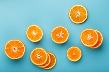 Slices and slices of orange pulp on a bright blue background as a textural background, the substrate. Full screen Flat lay, top view. Food background