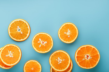 Slices and slices of orange pulp on a bright blue background as a textural background, the substrate. Full screen Flat lay, top view. Food background
