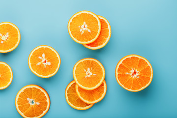Slices and slices of orange pulp on a bright blue background as a textural background, the substrate. Full screen Flat lay, top view. Food background