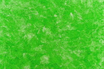 Obraz premium The texture of the plaster on the wall is painted in a green color. Background.
