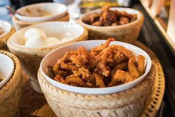 Hors-d'oeuvre ,Thai food Northern style: spicy minced pork salad, thai sausages, deep fried pork skin, spicy chilly paste, sticky rice and boiled egg.