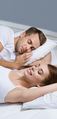 Fototapeta na wymiar Young couple sleeping on the bed