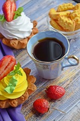 Fragrant tea and delicious cakes baskets of short pastry with jam and cream.