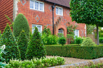 The view of a beautiful house exterior with garden and front door in England