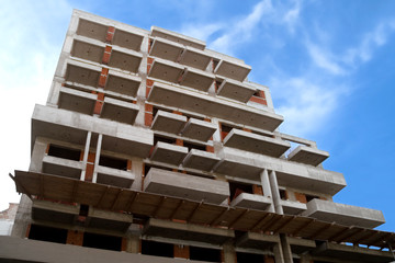 Building under construction against blue sky