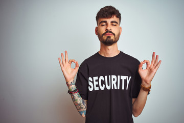 Young safeguard man with tattoo wering security uniform over isolated white background relax and...