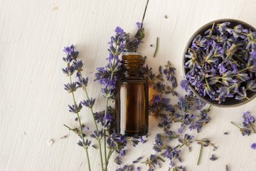 Provencal herbs. lavender oil in a glass bottle. A bowl with flowers on a white background.