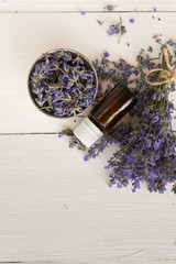 on wooden background set for spa treatments lavender bouquet for the bathroom aromatherapy oil for massage.