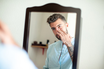 young tattoo man in the mirror