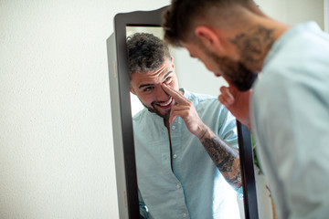 young tattoo man in the mirror