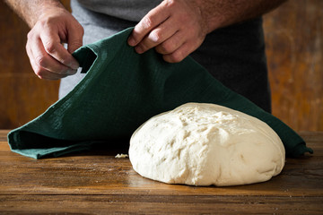 Fresh dough for preparing homemade bread on wooden table